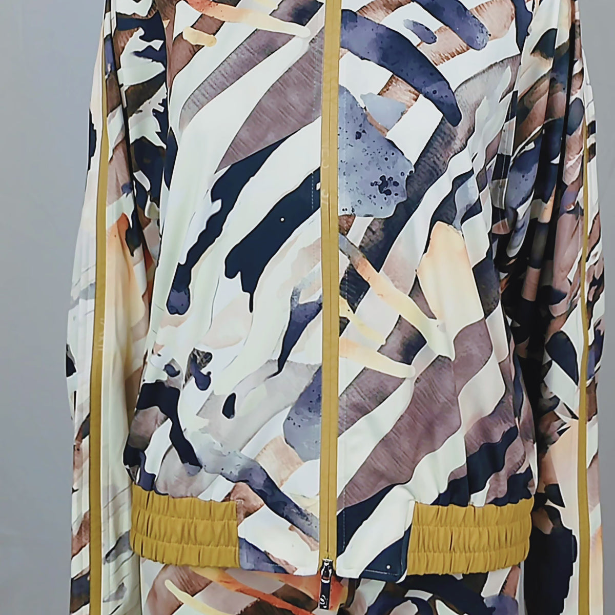 Close-up of women's Safari Ink jacket showing full front zipper, high collar and abstract neutral print.