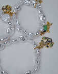 Harbor Grace bracelet stack featuring irregular luminous pearls with sculptural seahorse and ocean inspired charms.
