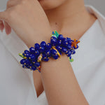 Caicos Bib- Sassy Jones,  arm candy, Hand-beaded teardrop beads, sea creature charms, wedding accessories, vacation jewelry, turks and caicos,Stretch bracelet -Multi-strand, multi-faceted cobalt blue teardrop resin bead base -Hand-painted resin-filled sea creature charm dangles -Curvy wrist-friendly