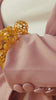 Close-up of gold stretch bracelets featuring intricate cutout sphere beads and dimensional textured details.