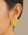  Colorful heart stud earrings featuring a yellow finish, red, blue and green crystals, and polished gold detailing.