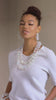 Layered iridescent bubble necklace with glossy clear beads reflecting rainbow tones in a soft multi strand design.