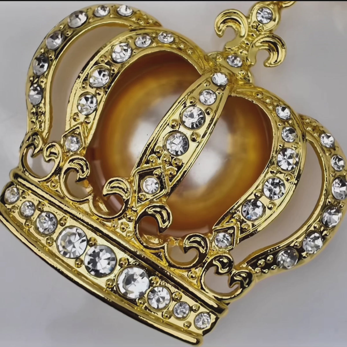 Sassy Jones Reign necklace with champagne pearl beads, metallic gold beads and crystal embellished crown pendant.