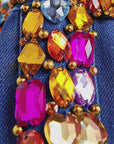 Close up of Gemma Crystal Jogger Jacket featuring multicolor faceted stones across the denim yoke and sleeves.