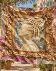 Oversized statement scarf featuring a cream colored sculptural bust with an elaborate loc updo and gold earrings.