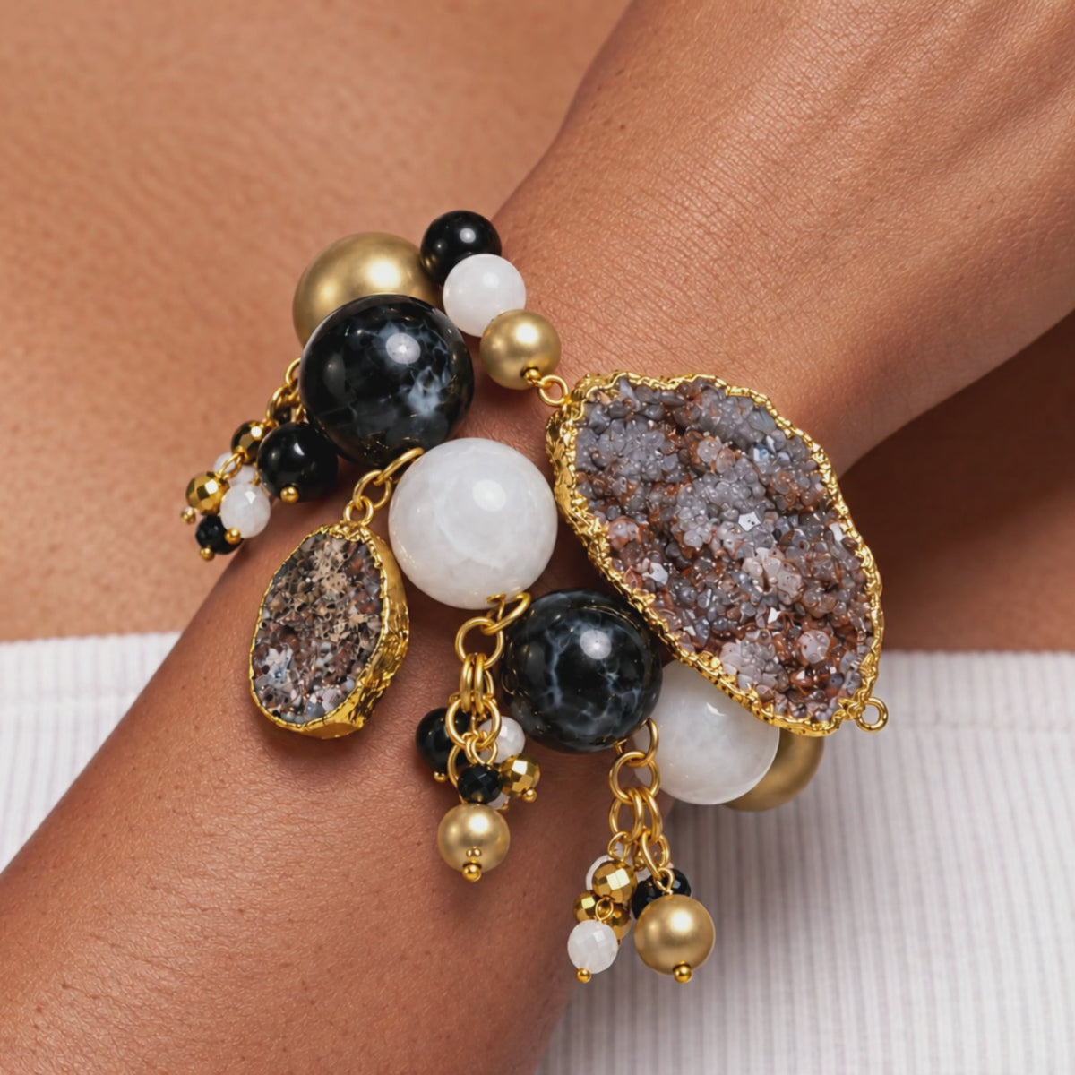 Close-up of Chrysallis chunky bracelet featuring organic agate stones, metallic gold beads, and small dangling accents.