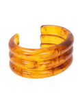 Triple layered amber marbled resin cuff bracelet with translucent honey and caramel swirls on a white background.