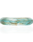 Aqua blue marbled resin bangle bracelet with ivory and taupe swirls in a tapered elongated silhouette on a white background.