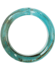 Aqua blue marbled resin bangle bracelet with ivory and taupe swirls in a tapered elongated silhouette on a white background.