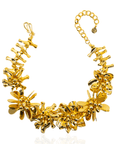 18k gold sculptural floral statement necklace with layered petals and reflective discs inspired by cascading wisteria blossoms worn on a woman's neckline
