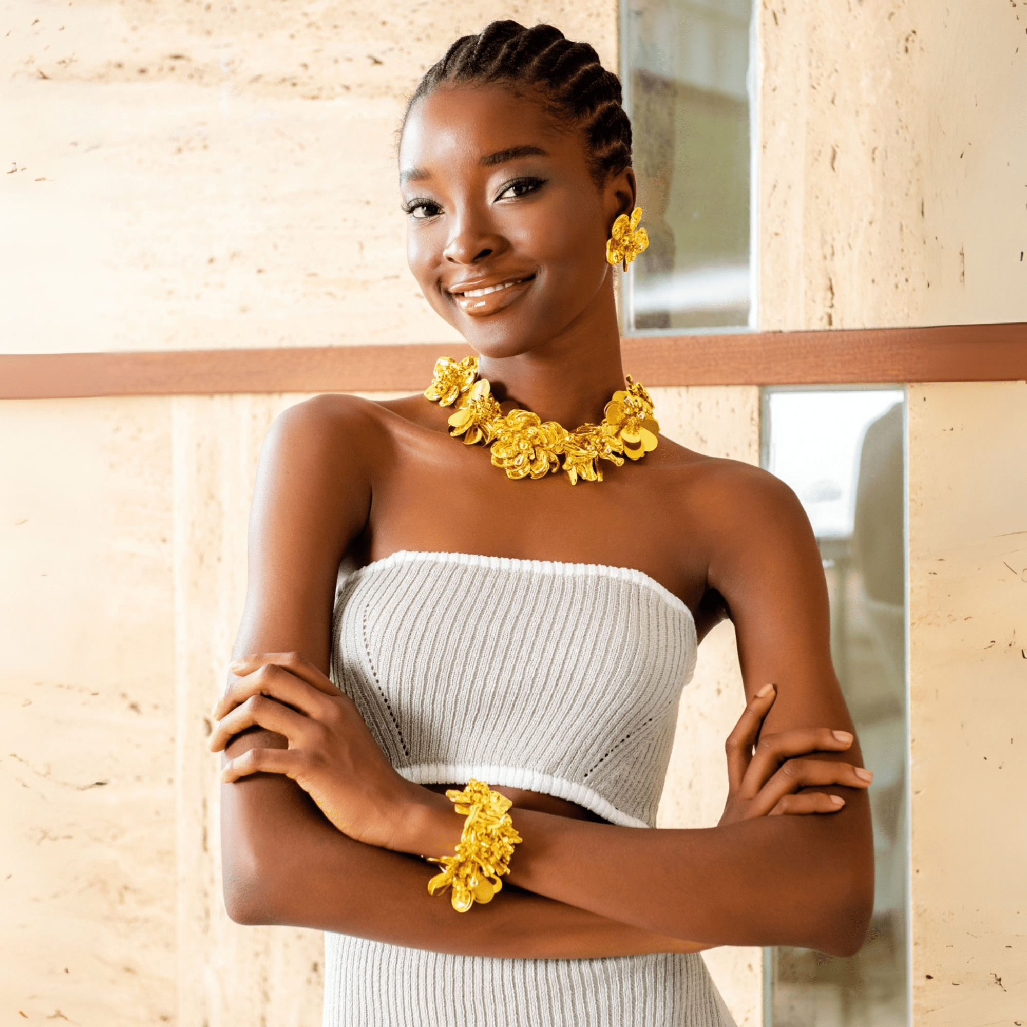 18k gold sculptural floral statement necklace with layered petals and reflective discs inspired by cascading wisteria blossoms worn on a woman's neckline