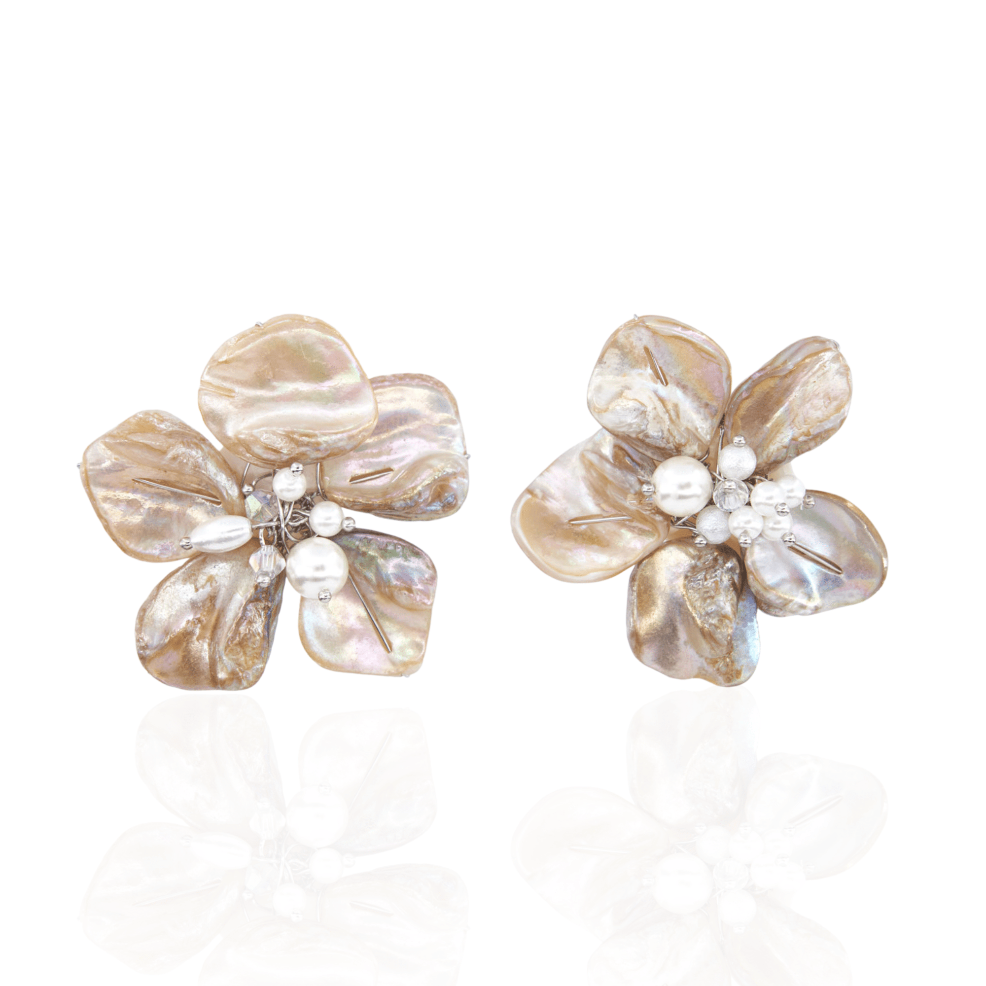 Mother of pearl floral statement earrings with pearl cluster center inspired by wisteria blossoms worn on a woman's ear