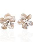 Mother of pearl floral statement earrings with pearl cluster center inspired by wisteria blossoms worn on a woman's ear