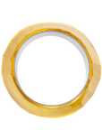 Faceted translucent golden resin bangle bracelet with sculptural modern shape on a white background.