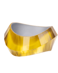 Faceted translucent golden resin bangle bracelet with sculptural modern shape on a white background.